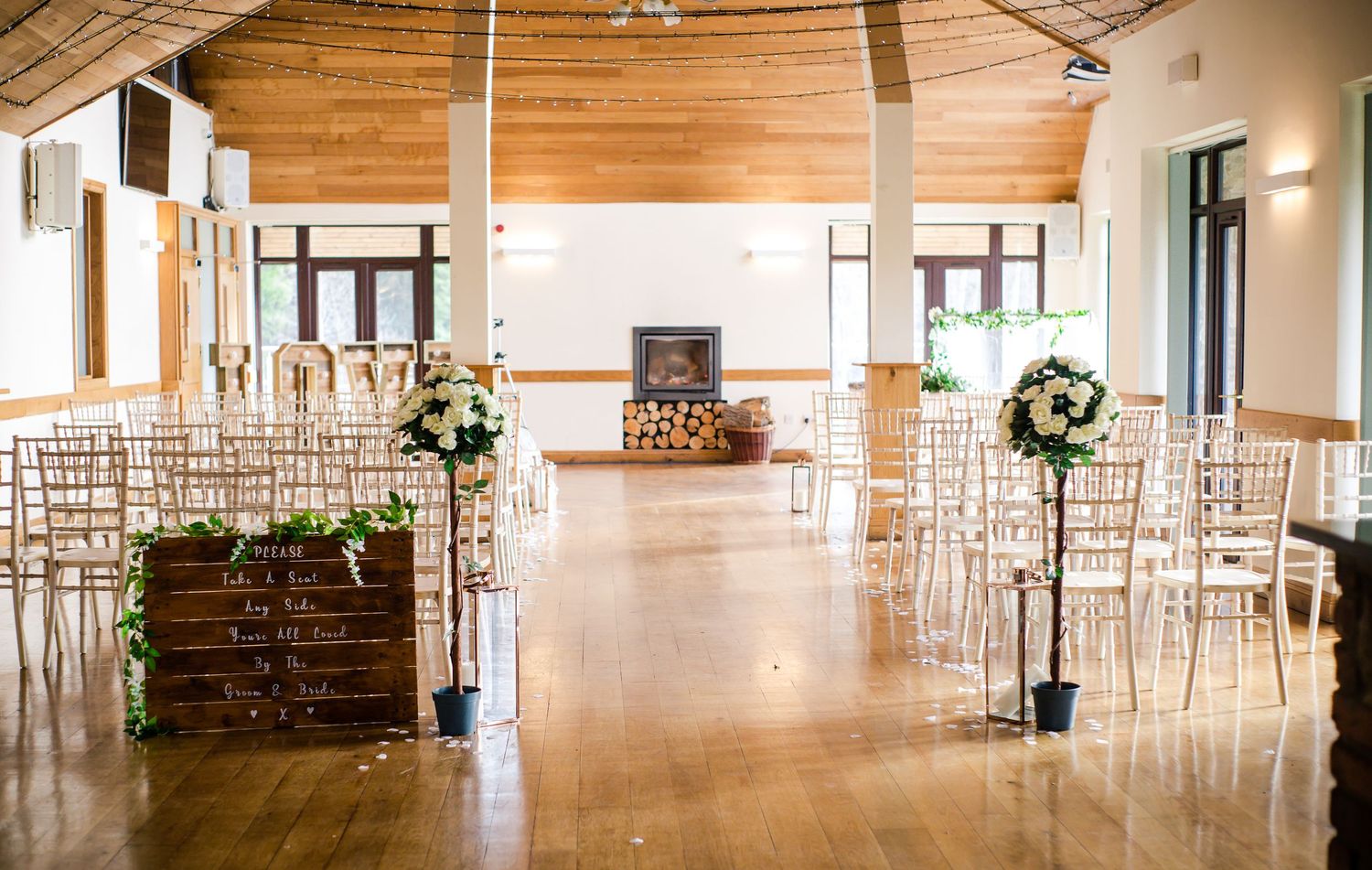 Rustic indoor wedding ceremony room prepared at Canada Lodge in Cardiff