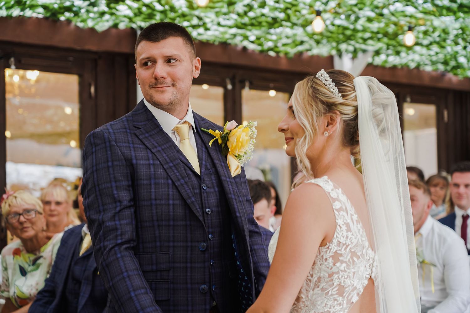Bride and groom smiling at one another during their wedding ceremony