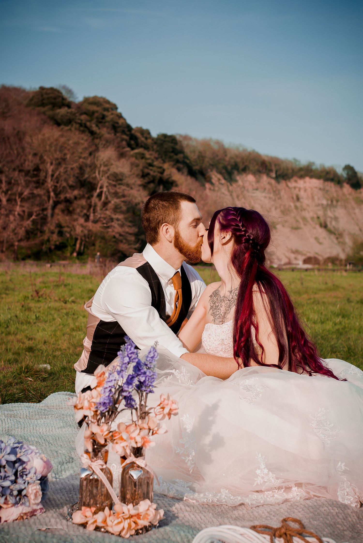 Bride and groom enjoying a romantic picnic at Porthkerry Country Park