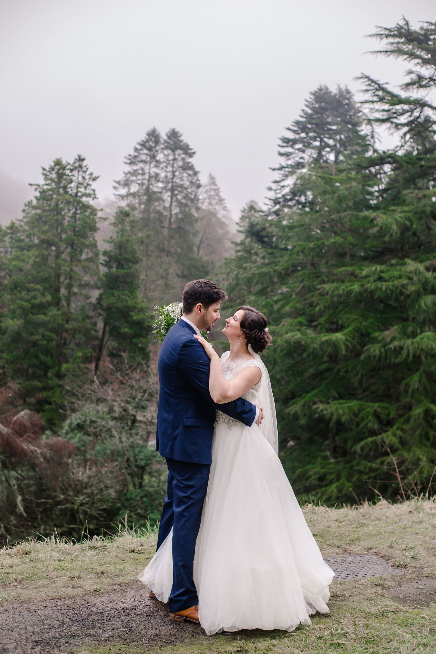 Bride and groom sharing a quiet kiss in the Craig y Nos Castle gardens