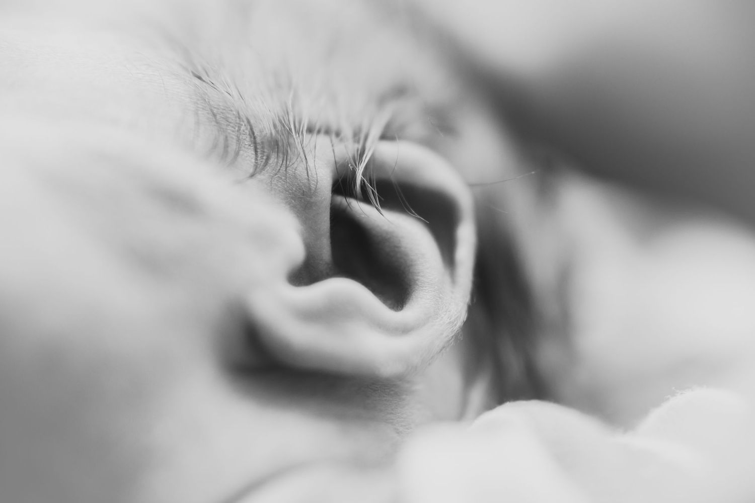 Black and white close-up of a newborn baby’s ear