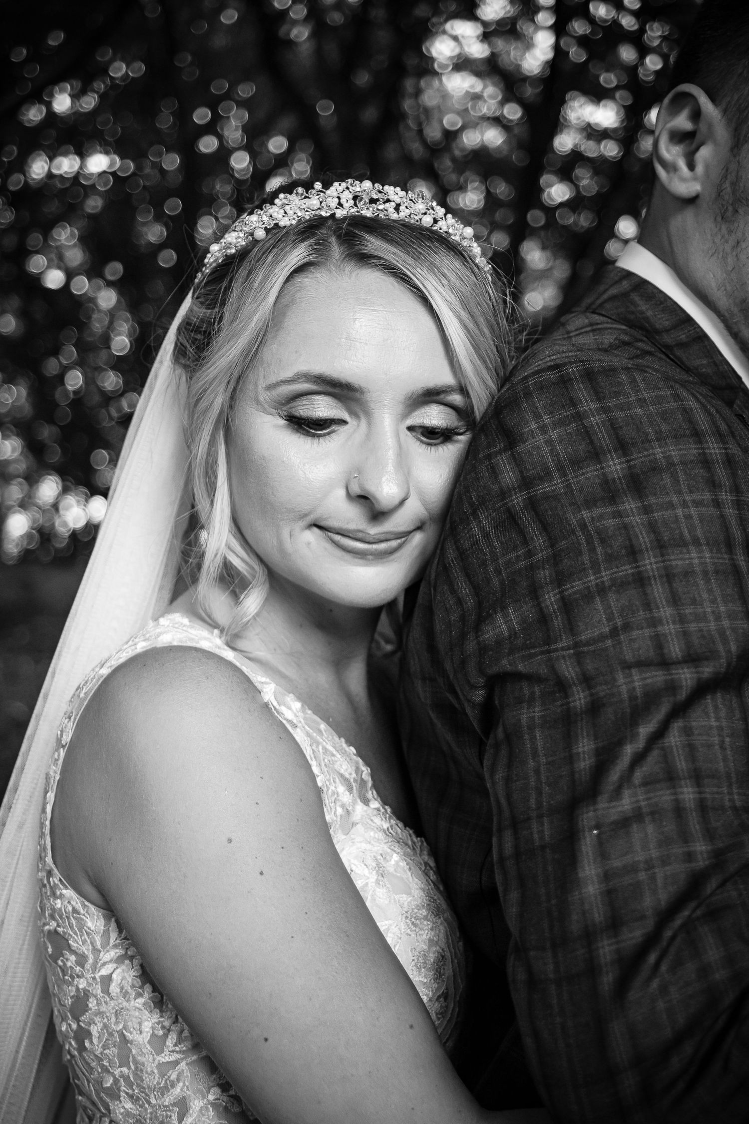 Black and white portrait of the bride resting against her groom at Ridgeway Golf Club