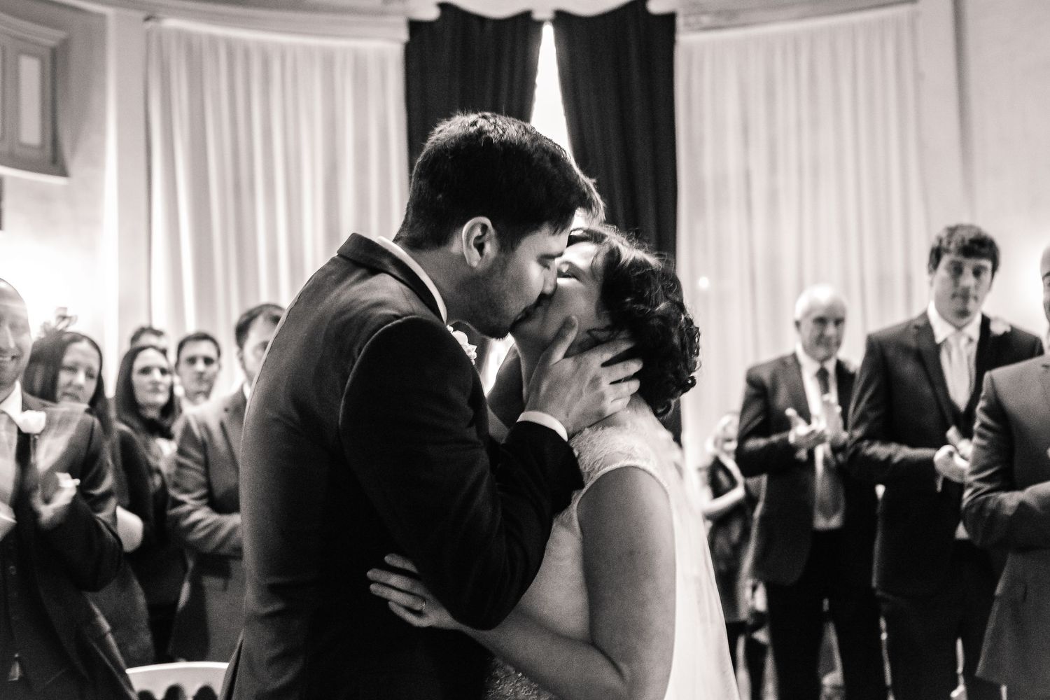Black-and-white photograph of the newlyweds’ first kiss inside Craig y Nos Castle