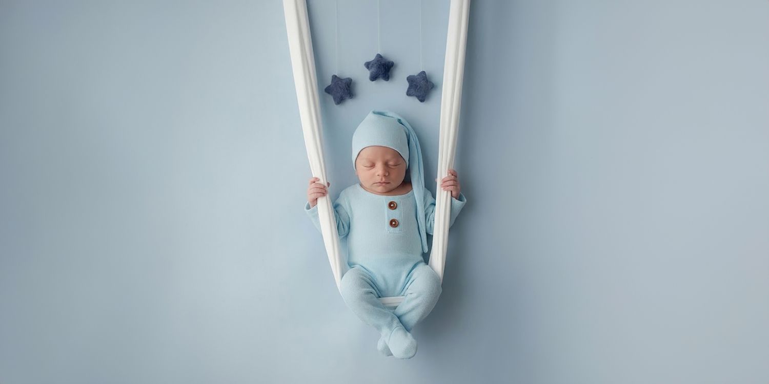 Professional newborn portrait session with custom prop setup in Philadelphia