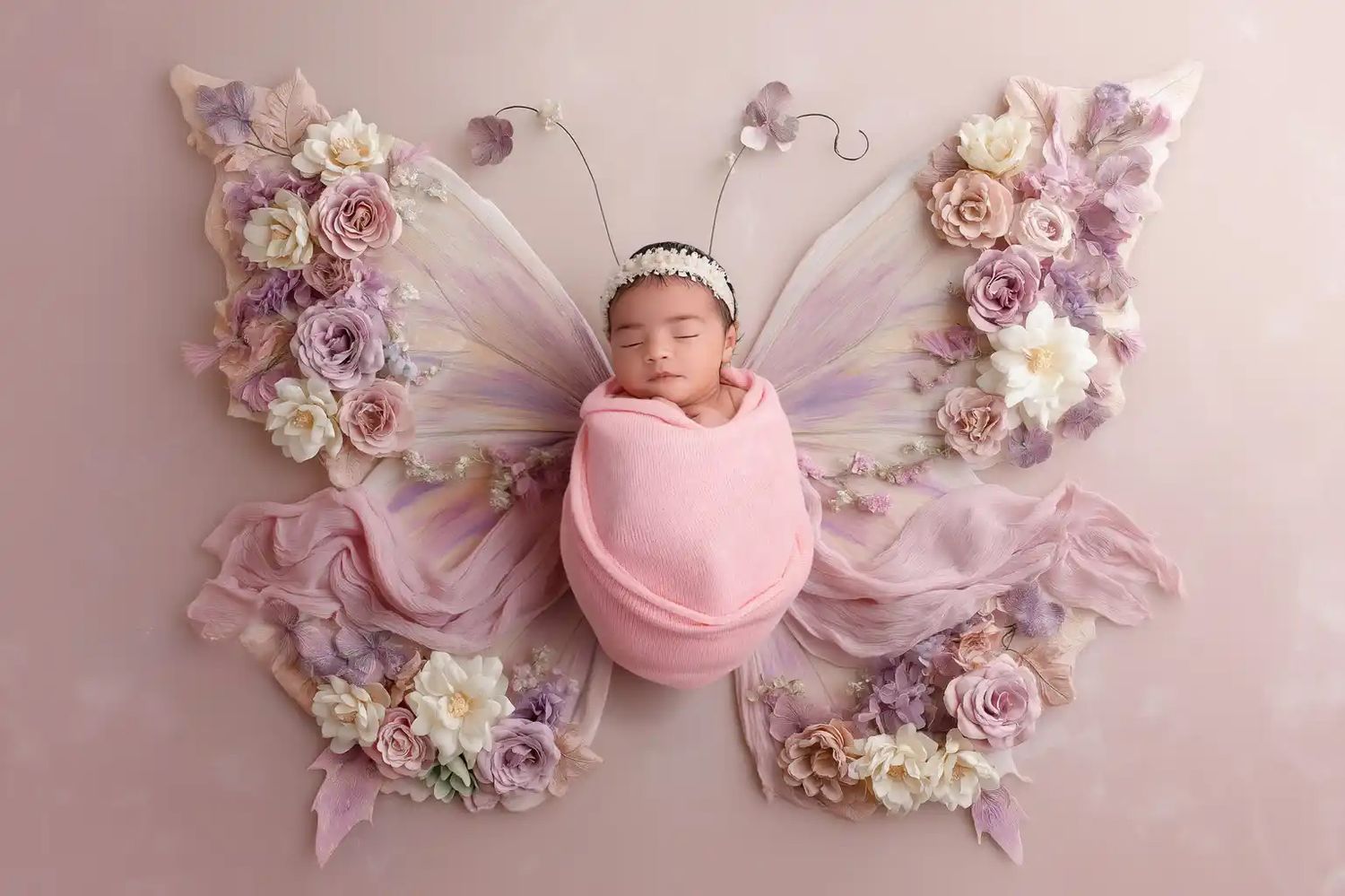 Fine art newborn girl portrait with luxury floral set in Philadelphia