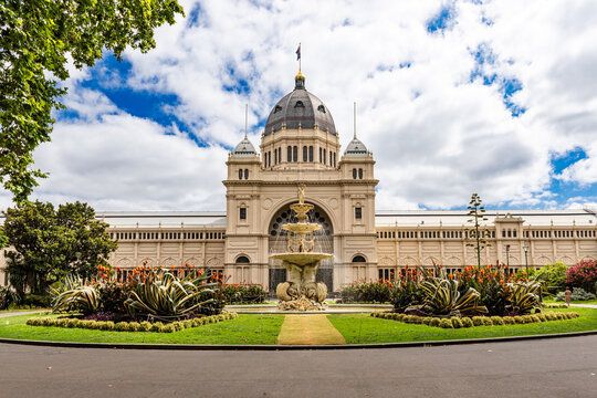 A panoramic view of the Royal Exhibition Building in Melbourne with its grand dome and ornate architecture against a cloudy sky.