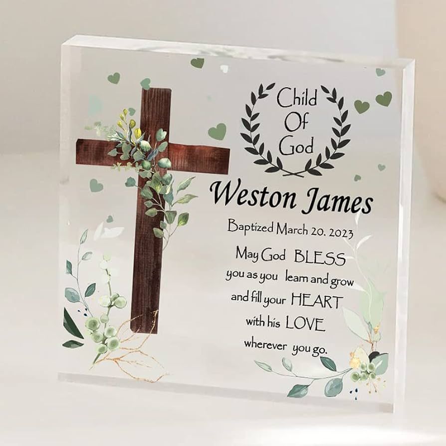 A religious baptism banner with crosses, eucalyptus leaves, and text reading 'Weston James' in a rustic style.