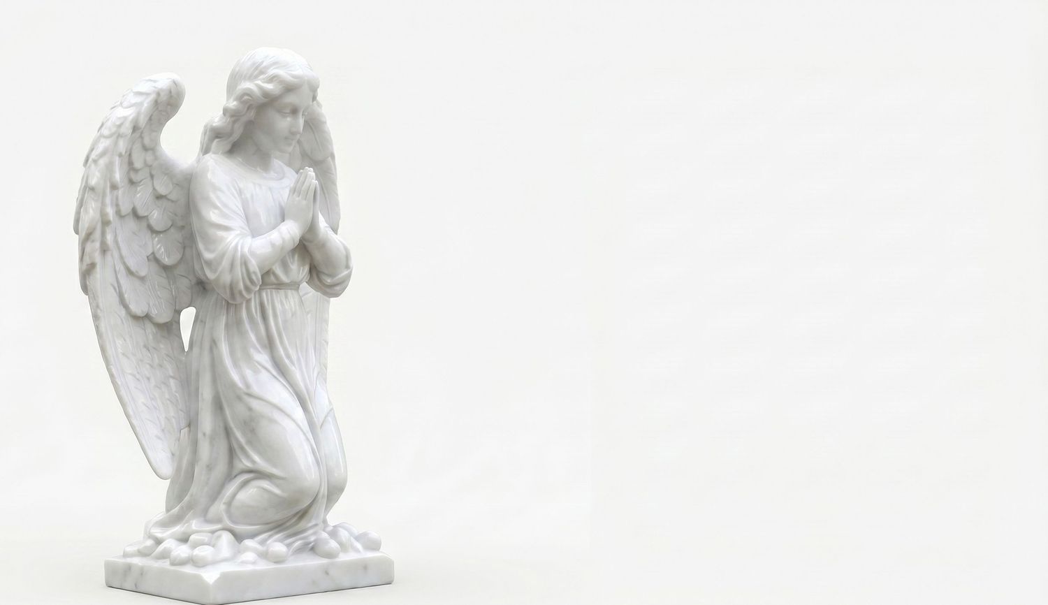 White marble angel statue with wings, hands clasped in prayer, on a plain white background.