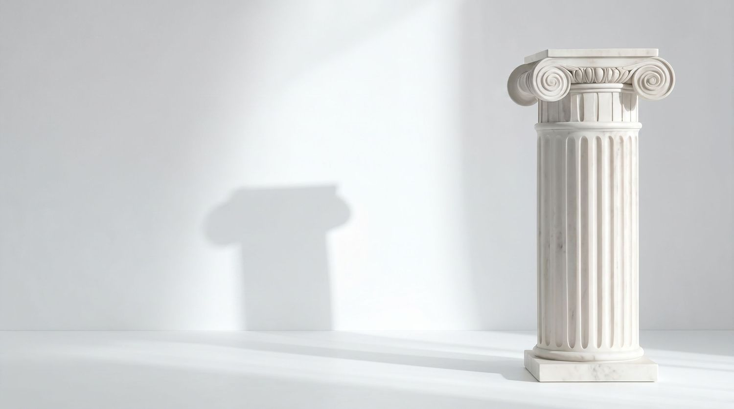 White marble Ionic column sculpture on a white surface with soft shadow, classical Greek architectural decorative pillar.