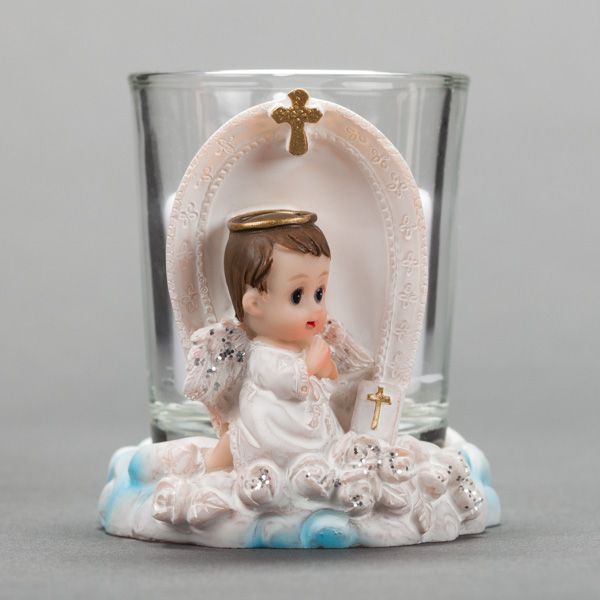Small decorative glass candle holders with delicate lace and cross details arranged in a row against gray background.