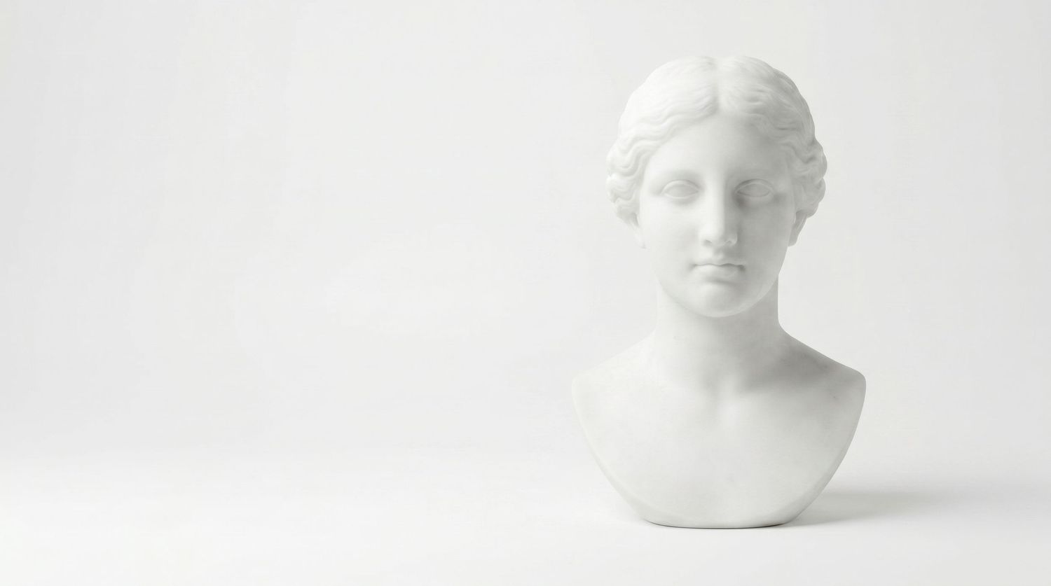 White marble bust sculpture of a classical Greek goddess on a white background.