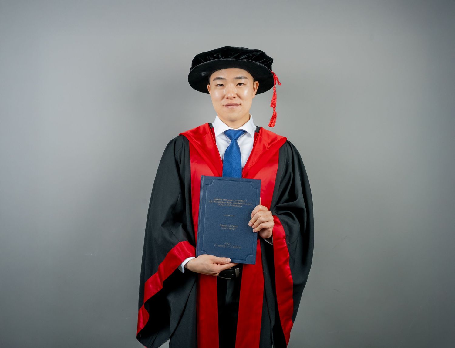 Portrait series showing someone in academic regalia with red accents against a grey studio background.