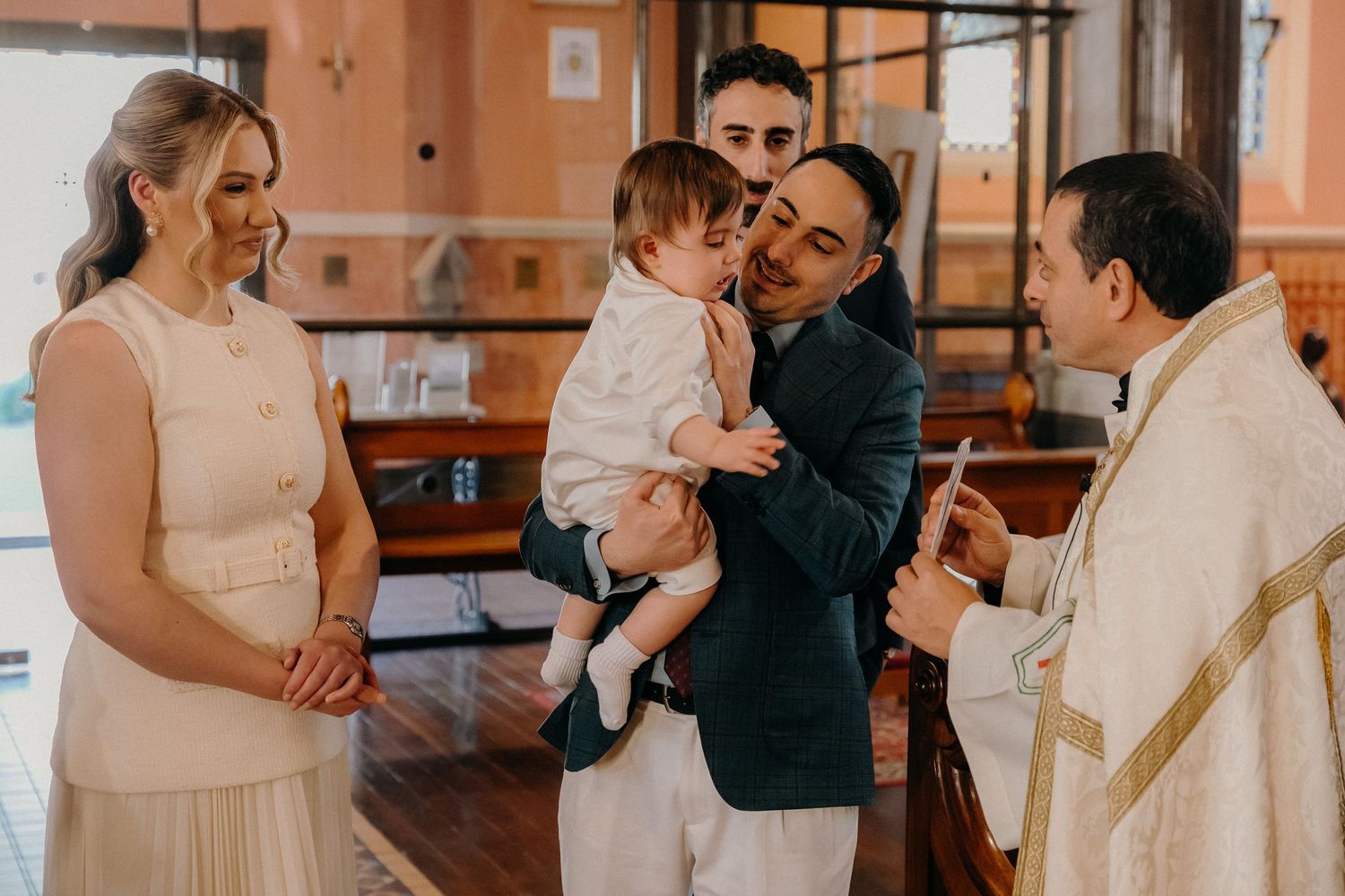 A series of candid moments during a wedding ceremony and reception showing guests embracing and celebrating together.