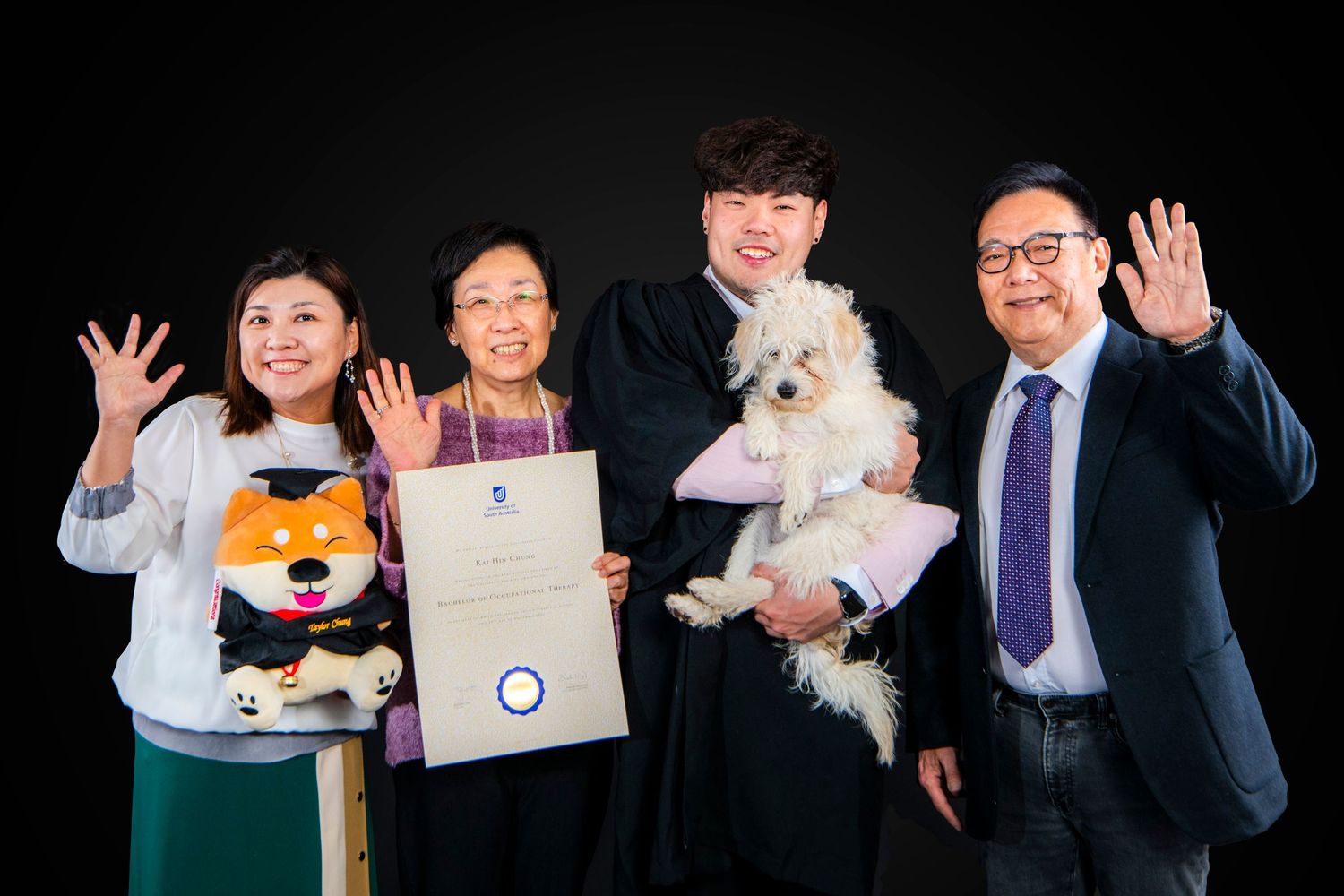 Business professionals pose with awards, certificates, and plush toys during a corporate recognition ceremony.