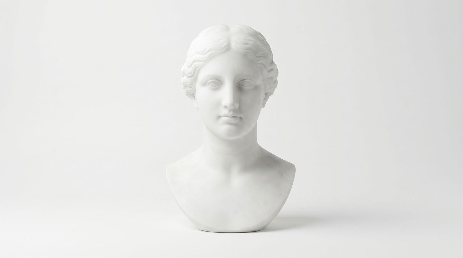 White marble bust sculpture of a classical Greek goddess on a white background.