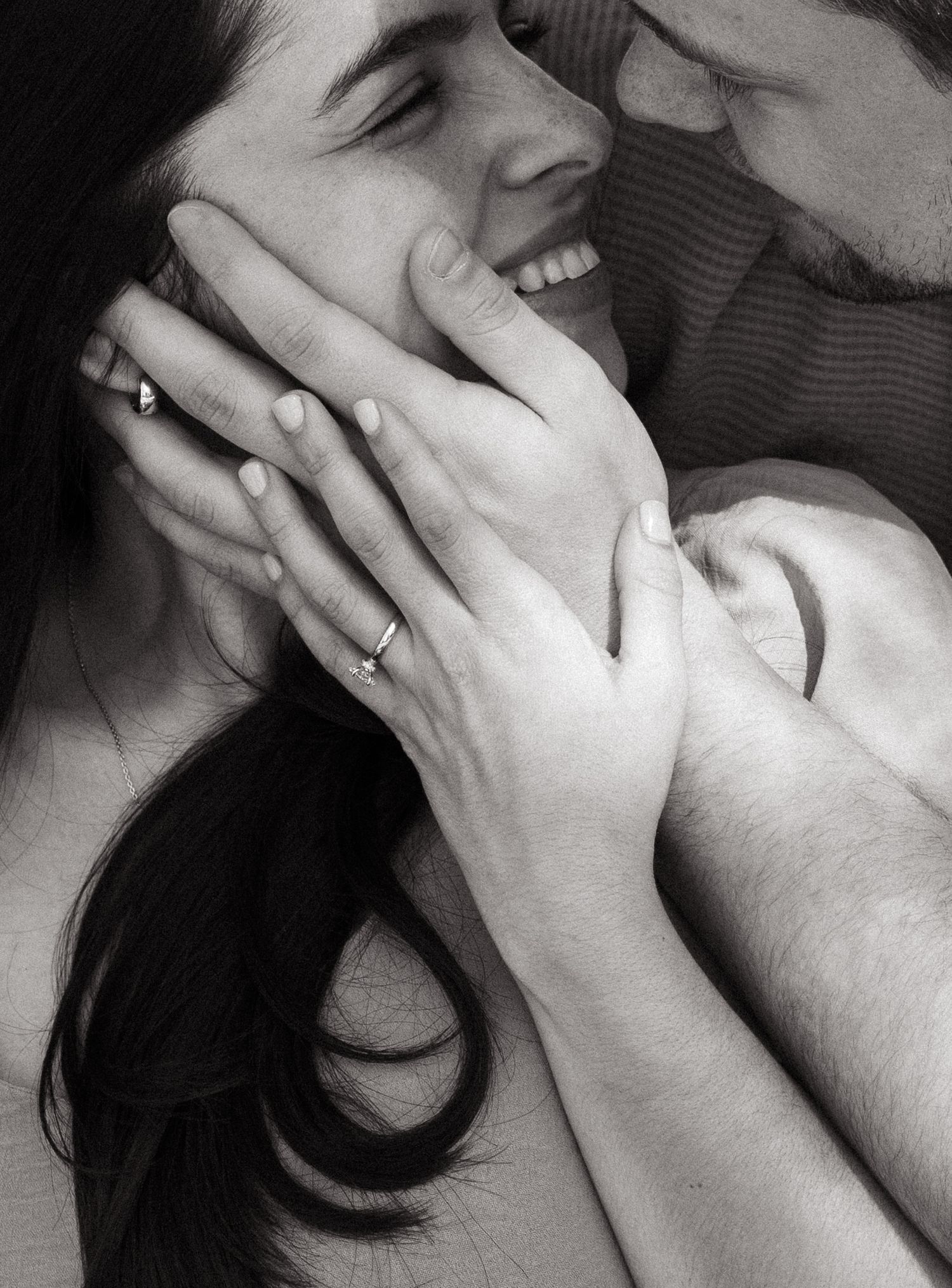 A romantic black and white close-up photo showing tender intimacy between a couple.
