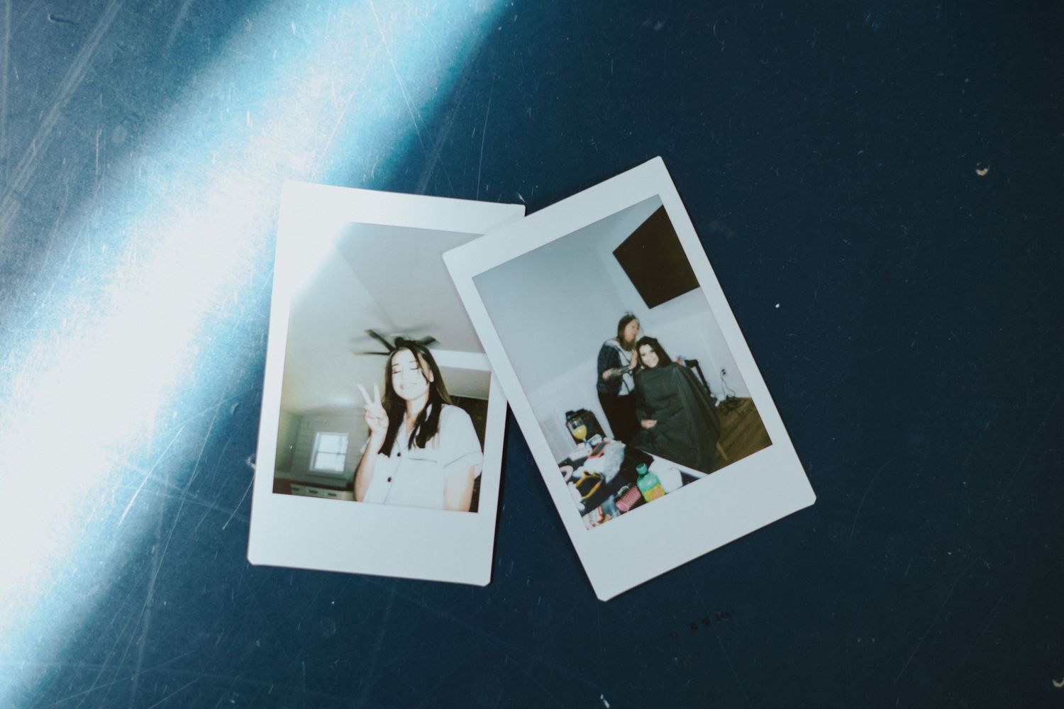 Two vintage-style polaroid photographs displayed against a dark blue background.