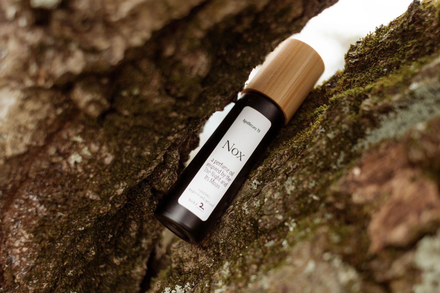 product photography, outdoor, nature, lifestyle, water, dark, moody, photographer, perfume oil, moss, hiking,