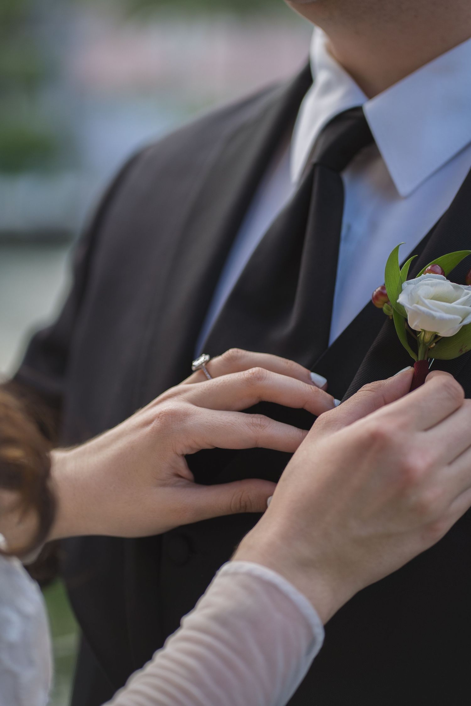 bride placing corsage on groom