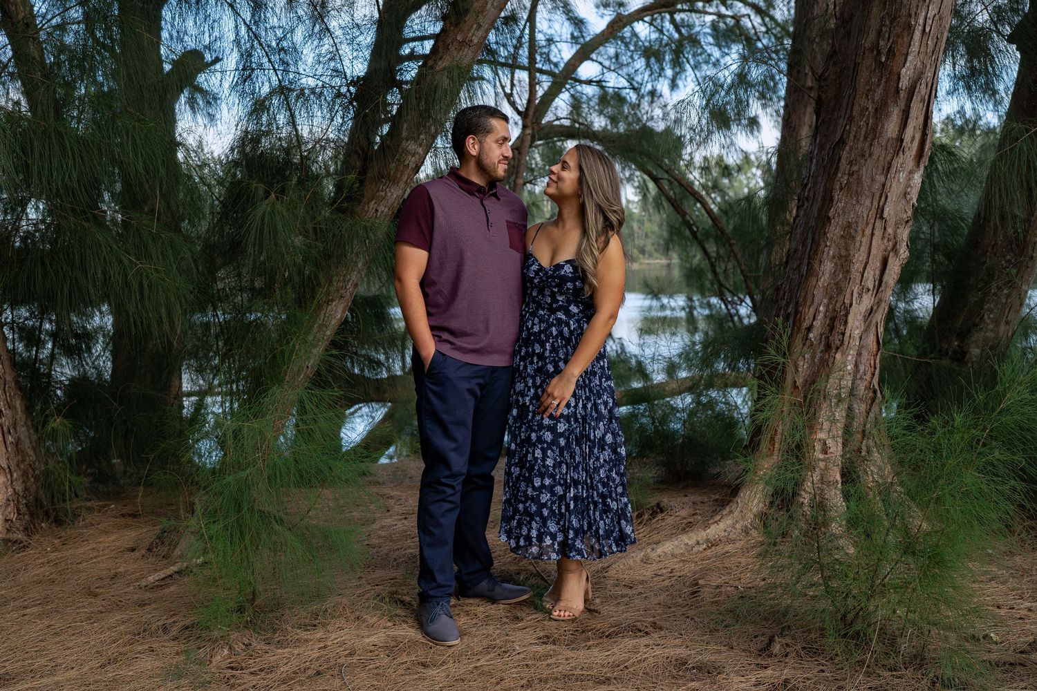 husband and wife staring at each other at a lake park