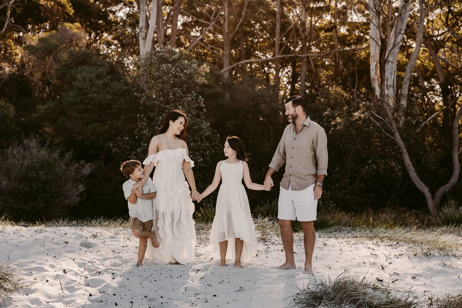 family-photo-sunset-greenfields-beach-vincentia-jervis-bay-family-four-hold-hands-backlit-by-sunlight