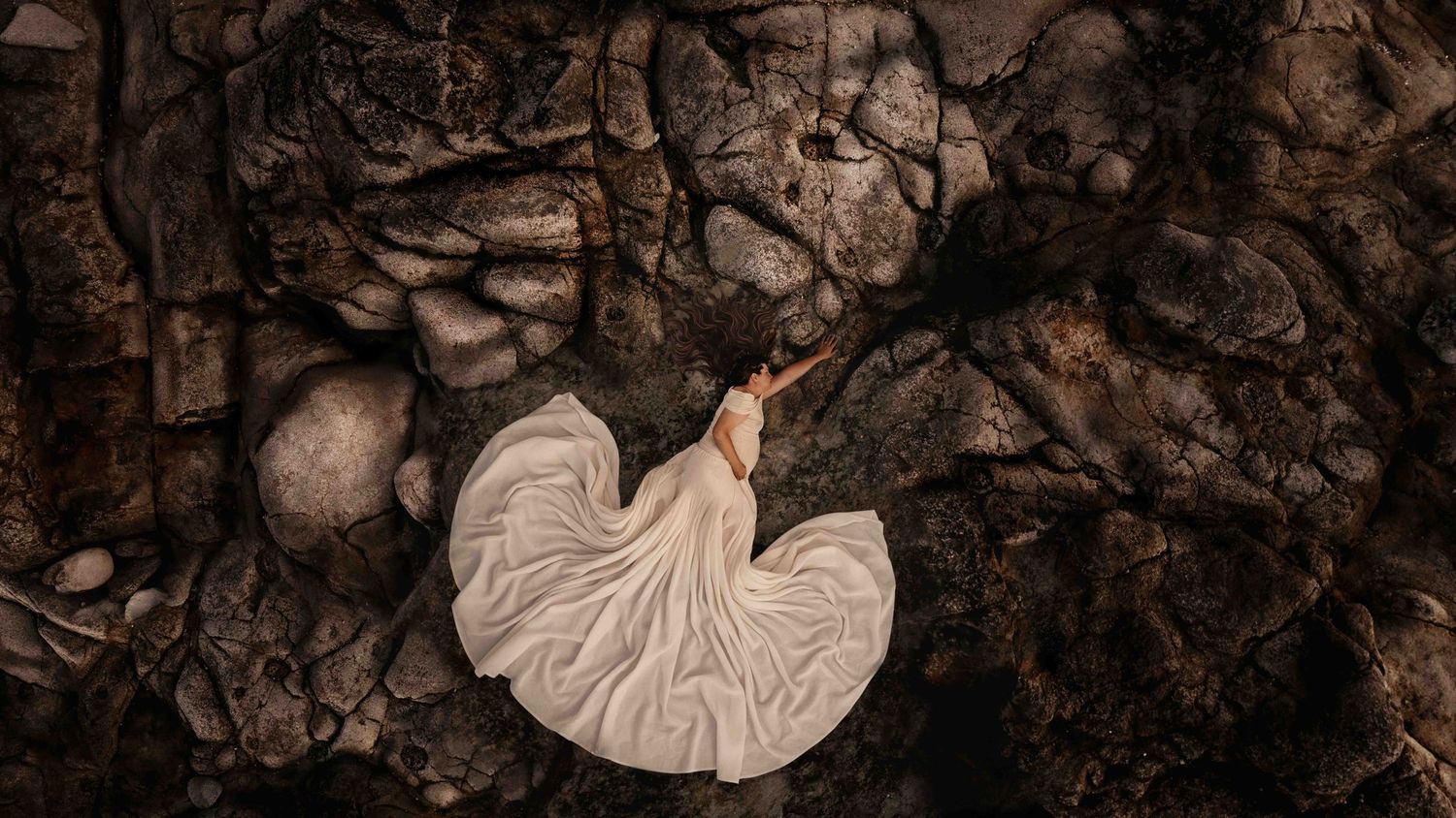 Aerial Drone Maternity Photograph- Pregnant momma, laying on rocks. Jervis Bay NSW- Claire Frances Photography
