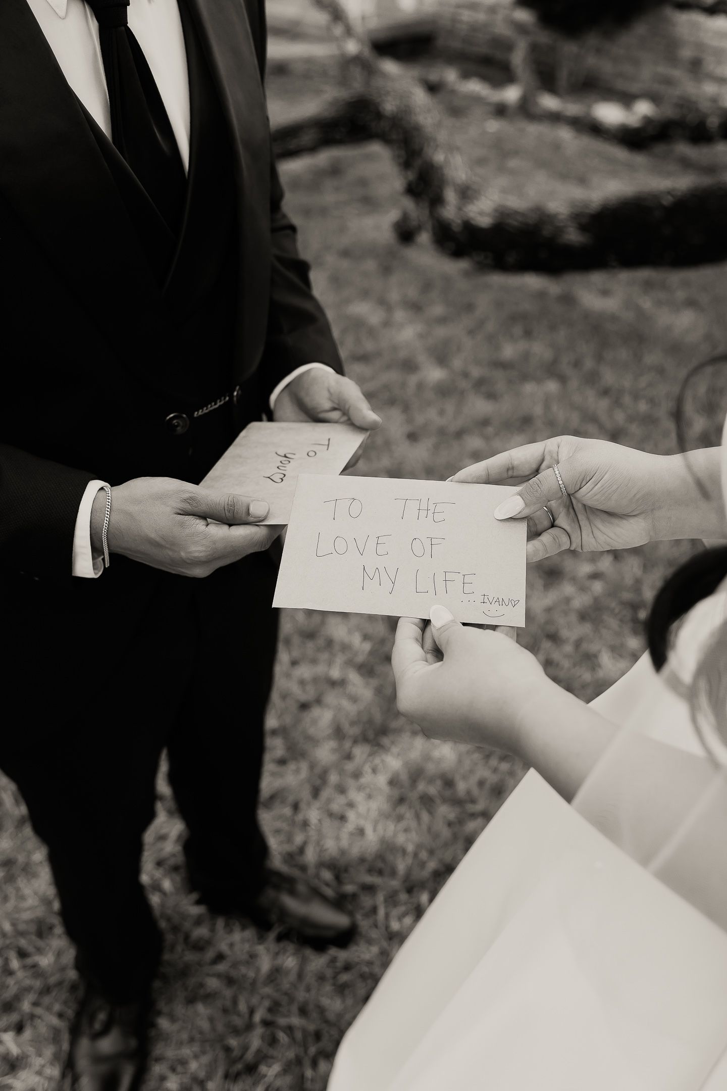 A series of black and white photos showing handwritten love notes being exchanged during a wedding ceremony.
