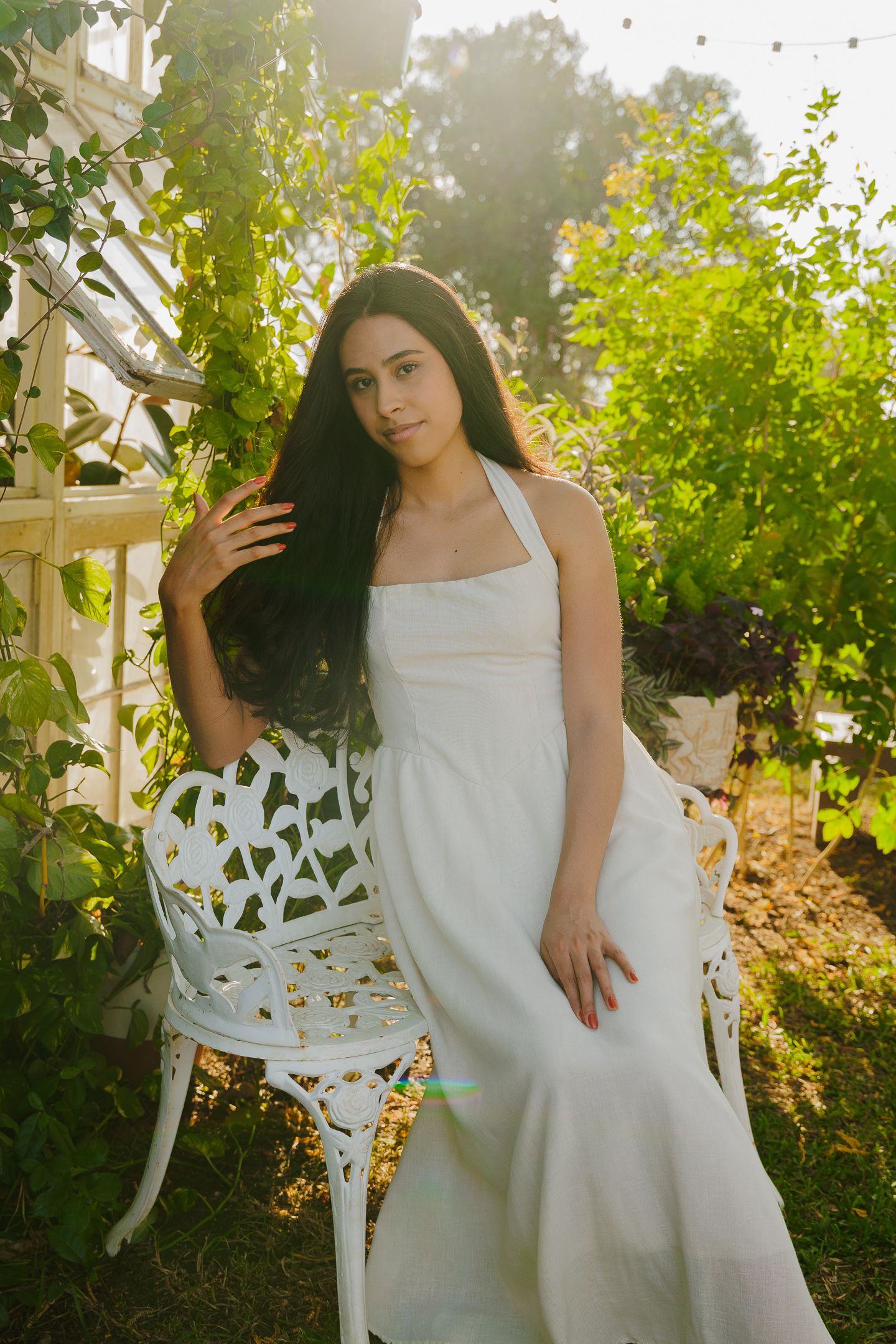 A series of outdoor garden photos featuring a white dress against lush greenery and decorative white furniture in sunlit setting.