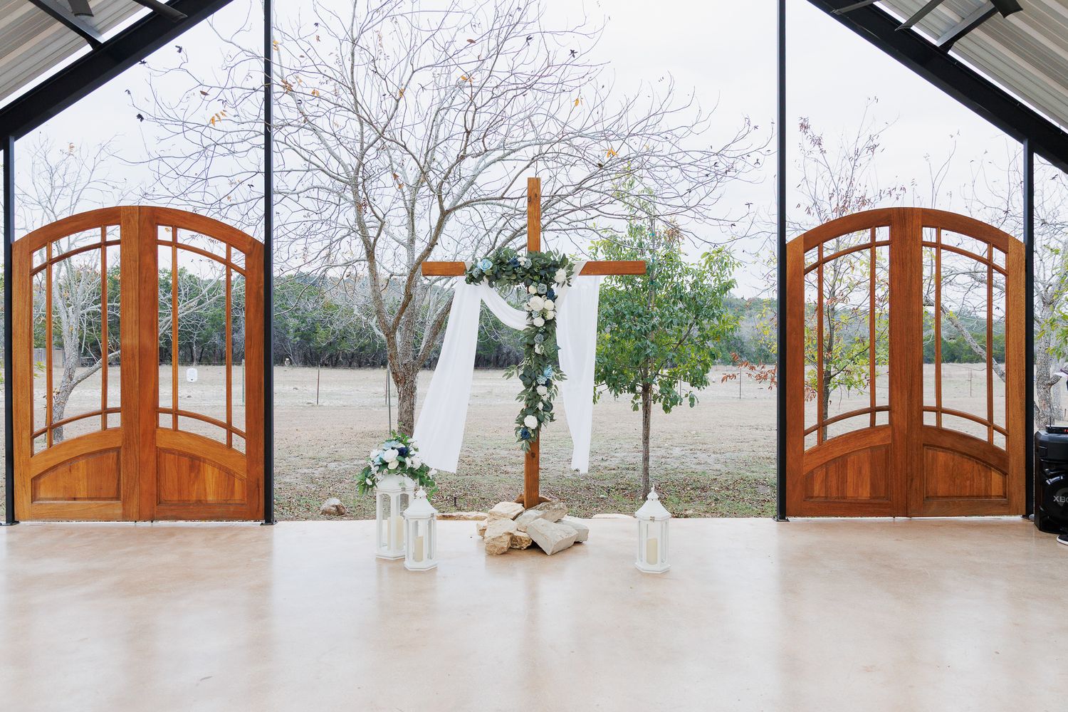 A series of wooden arched doorways and windows in a modern home interior with white walls and natural lighting.
