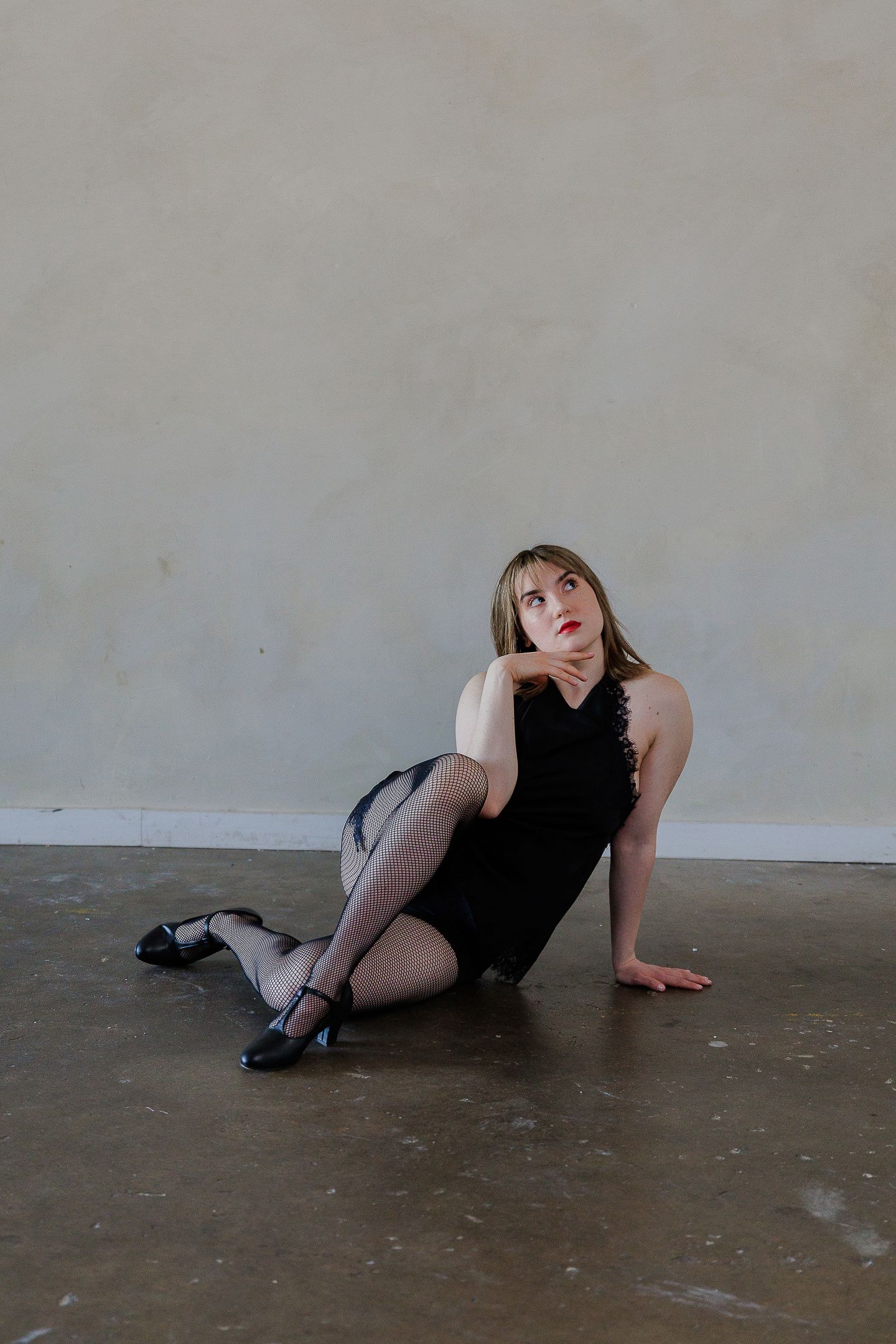 Dramatic dance poses captured in sequence showing movement across a concrete floor.