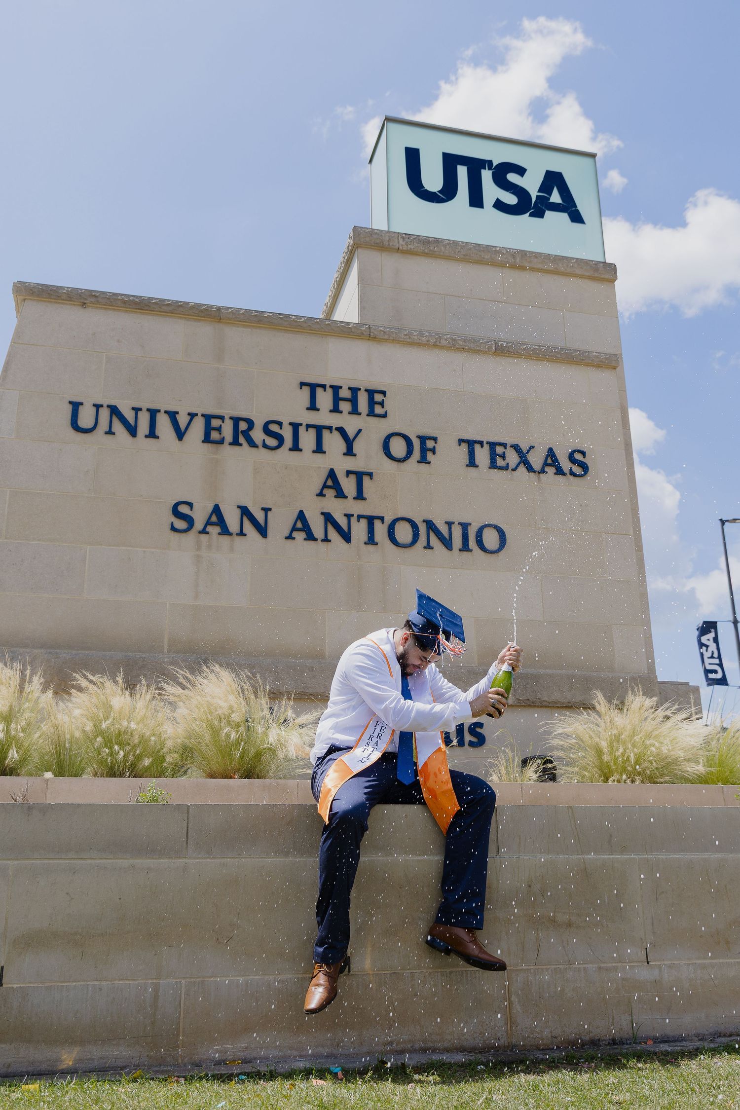 Four sequential photos showing someone climbing over a concrete wall with UTSA University of Texas at San Antonio signage.