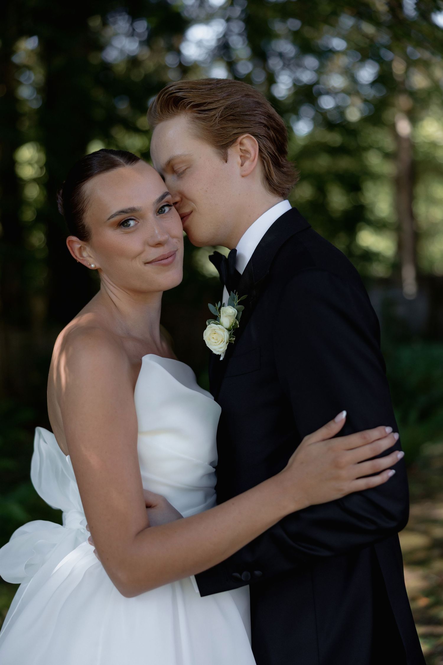 Intimate wedding photos showing tender moments between newlyweds in an outdoor setting.