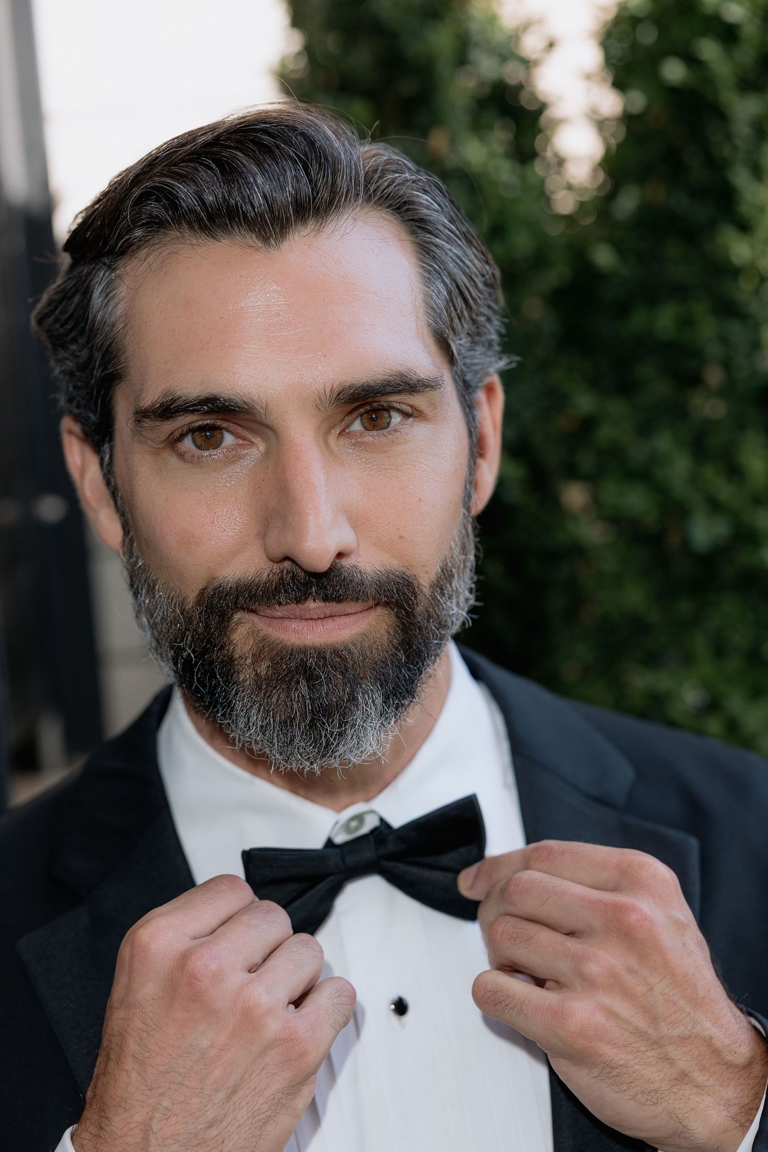 Classic formal portrait showing detail of black bow tie and white tuxedo shirt.