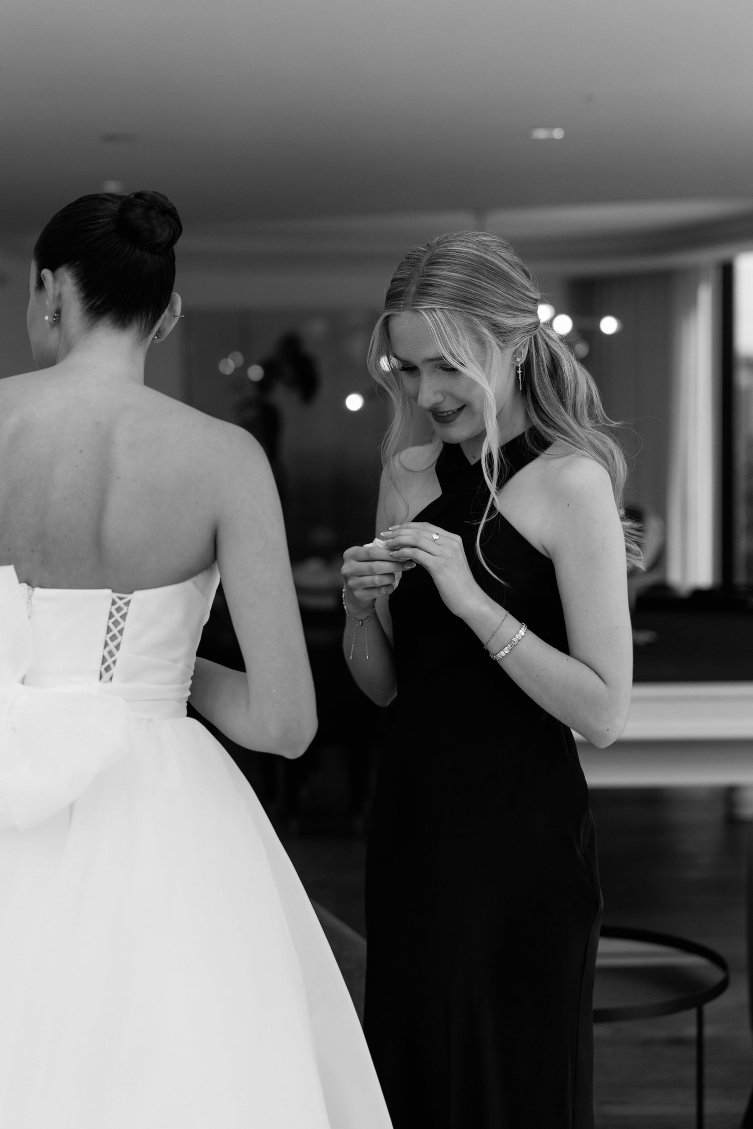 Black and white photo of formal wear details during a special event.