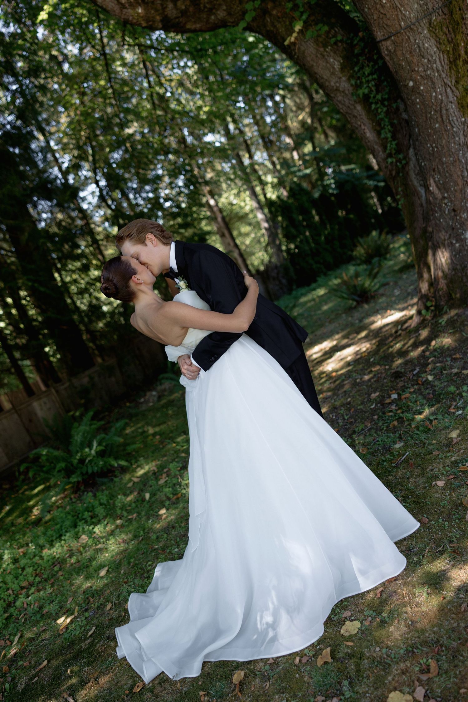 Romantic wedding dance poses captured in a wooded outdoor setting.
