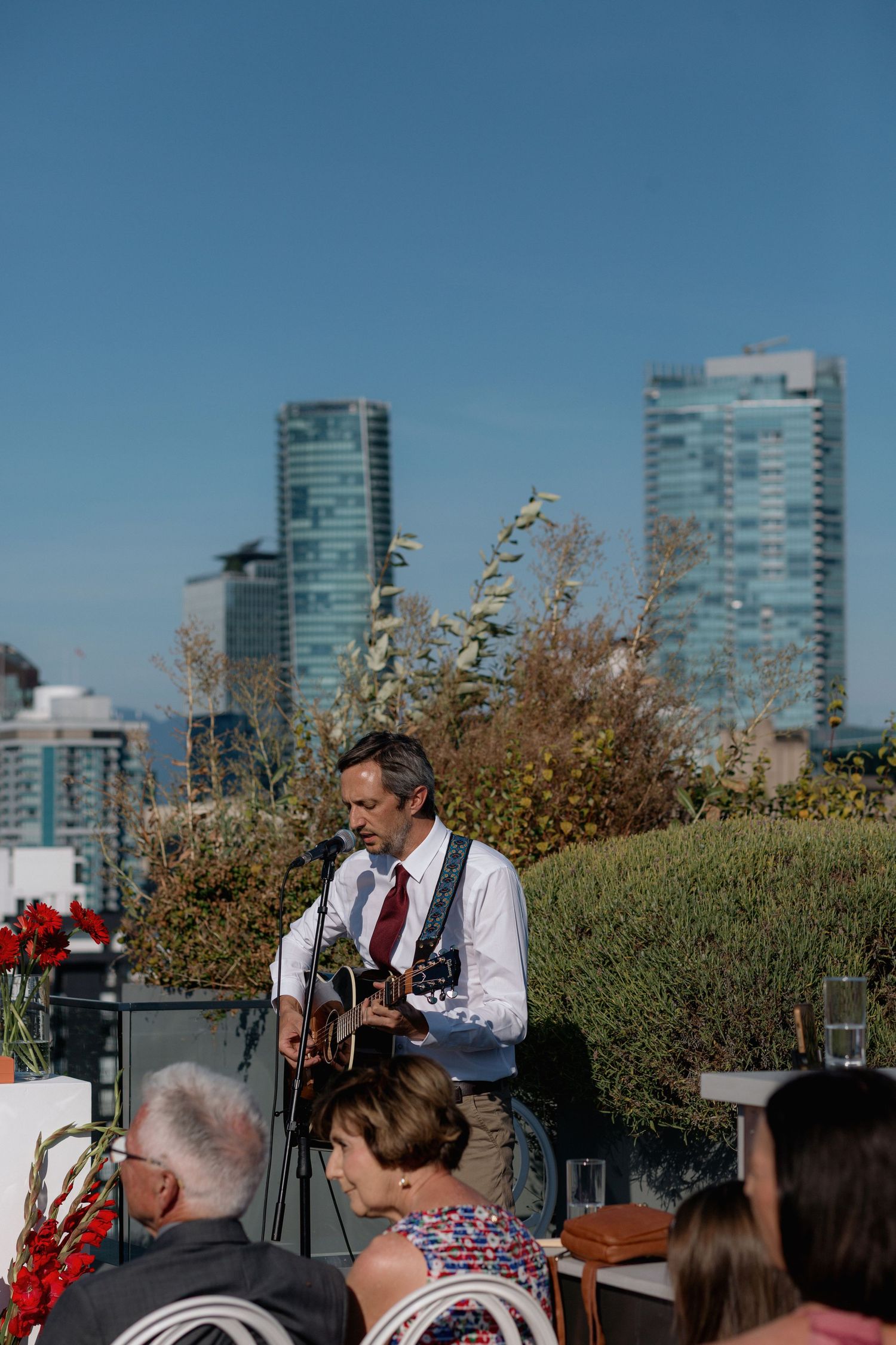Outdoor event setup with city skyscrapers visible in the background on a sunny day.