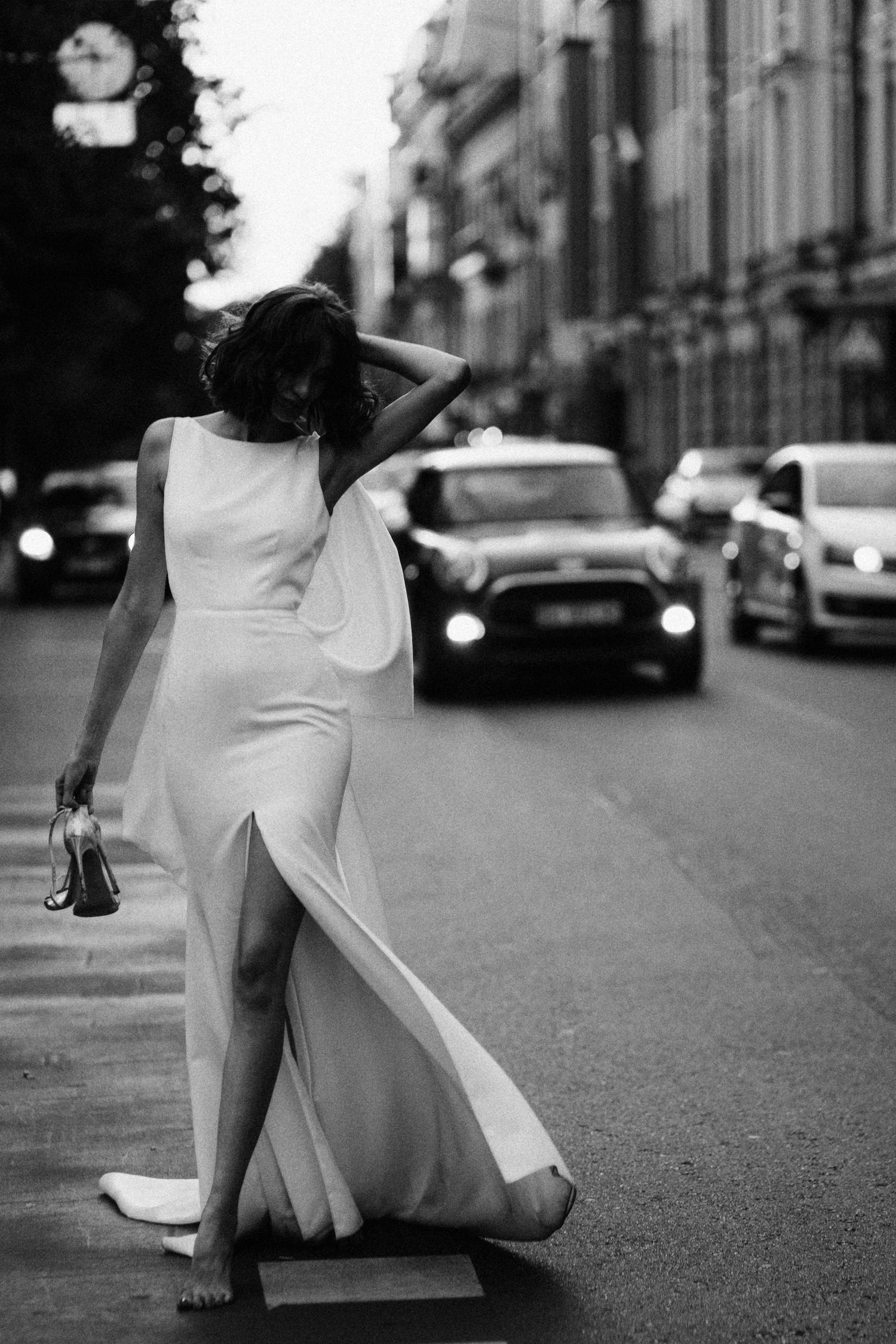 Black and white street photography sequence showing flowing white dress movement against urban backdrop.
