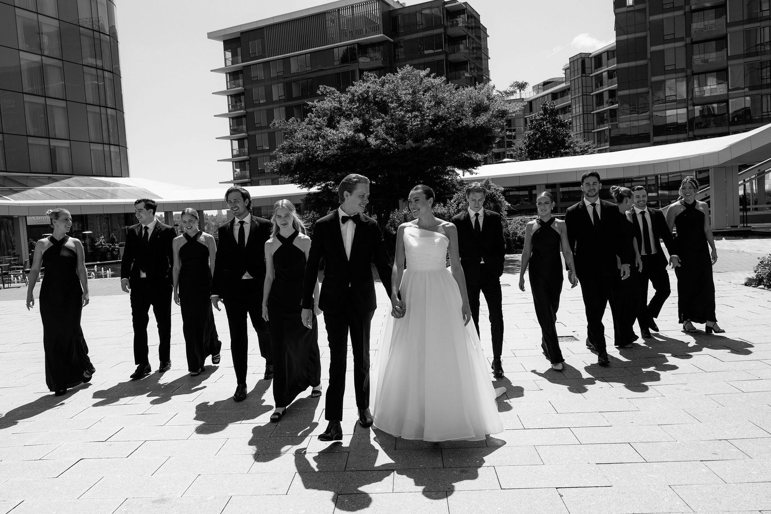 Black and white panorama of wedding party arranged on modern plaza at Marriott Hotel in Vancouver