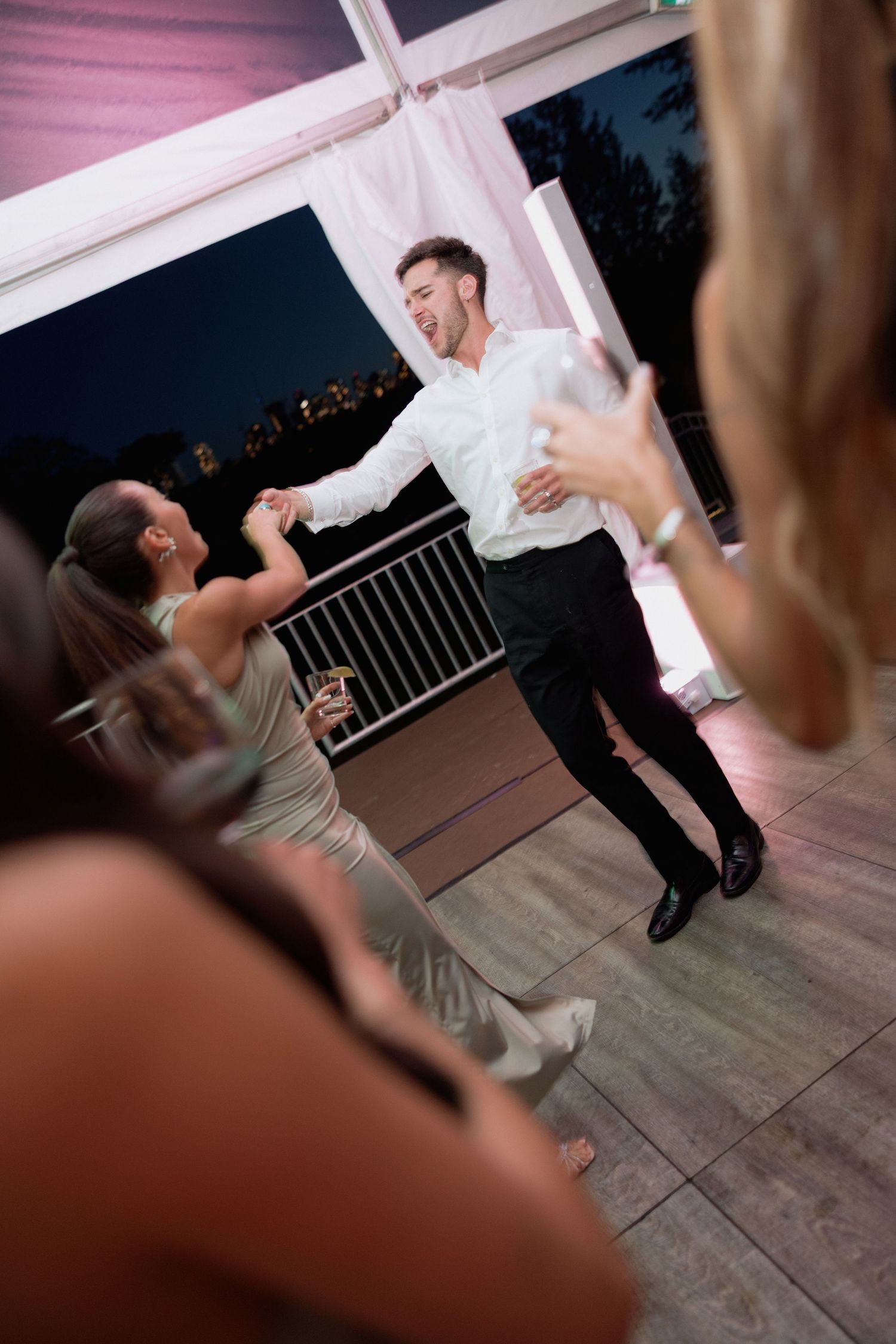 A sequence of dance moves showing a fun dip during a celebration on a covered patio.