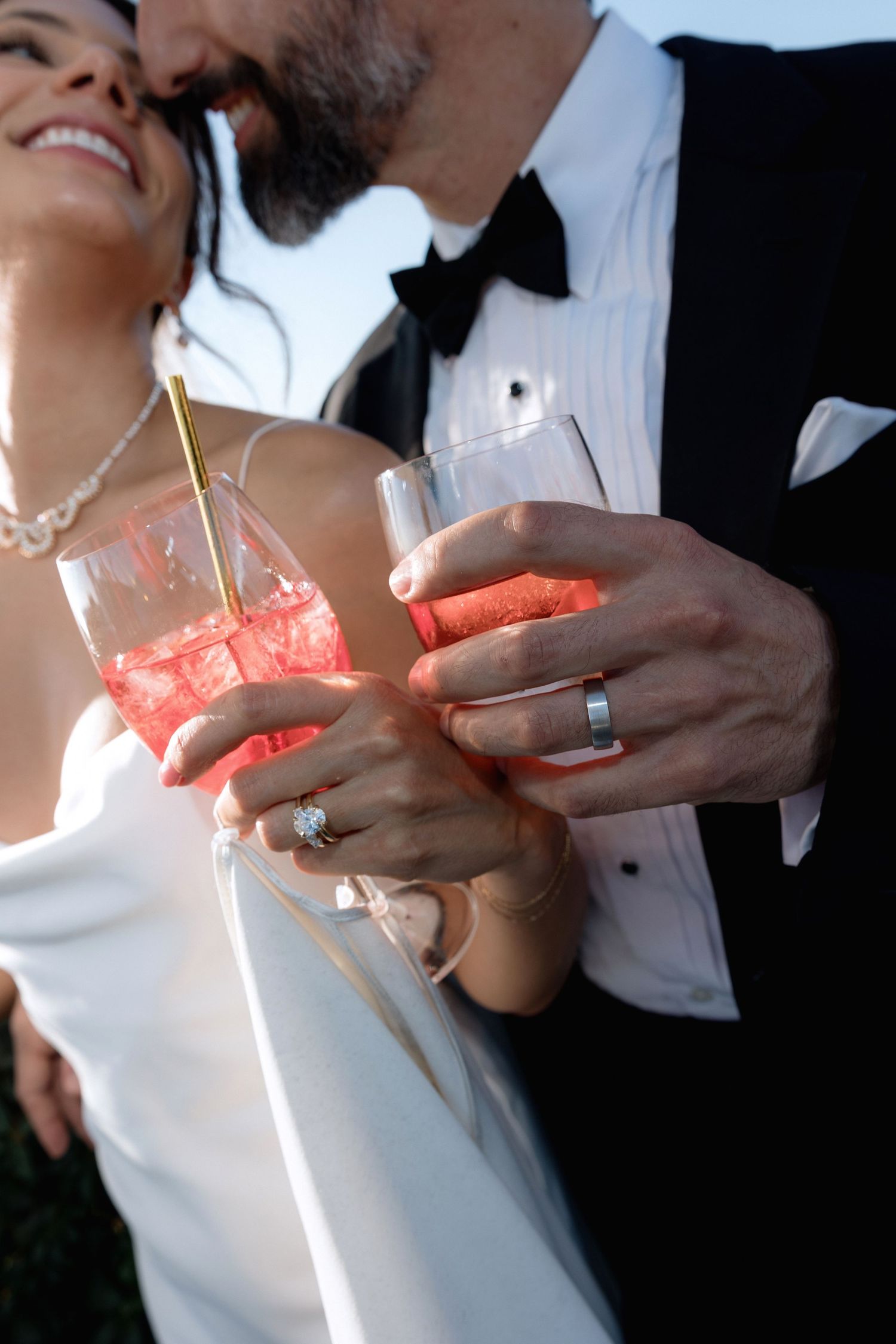 Close-up of hands holding lit sparklers during wedding celebration.
