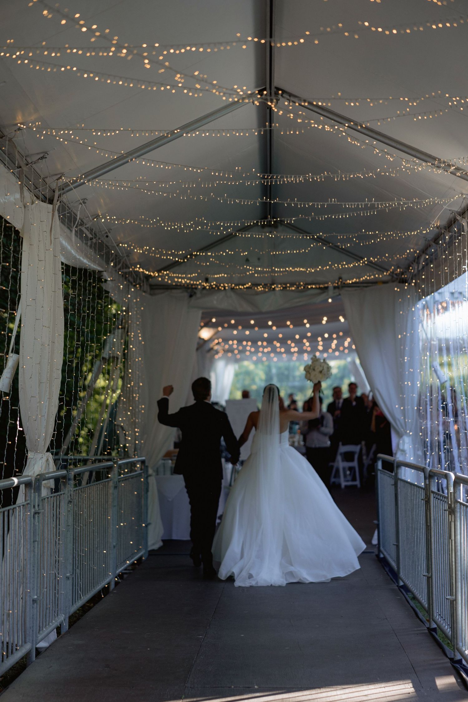 Wedding reception tent decorated with twinkling string lights creating magical ambiance.