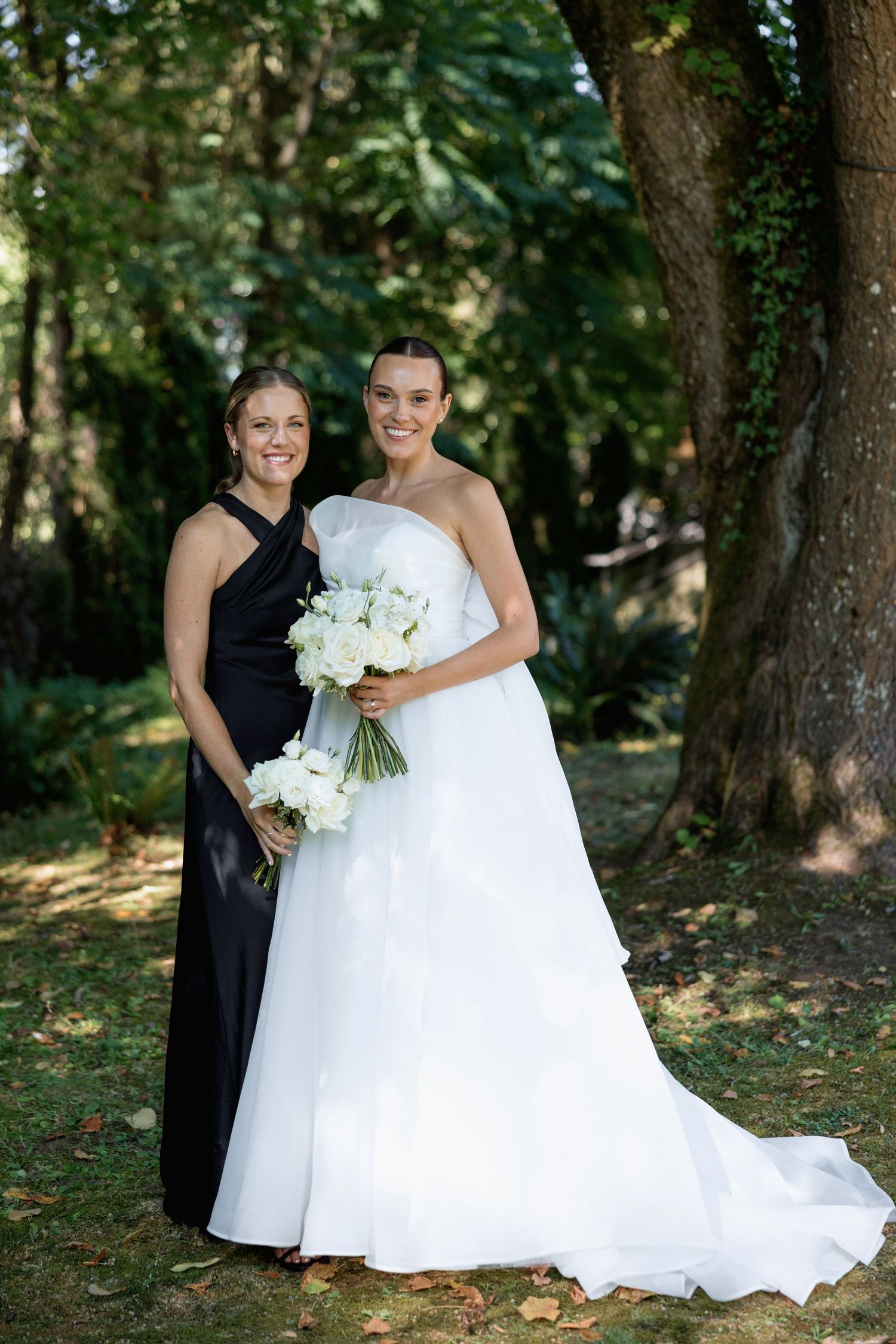 Intimate outdoor wedding portraits captured under forest canopy.