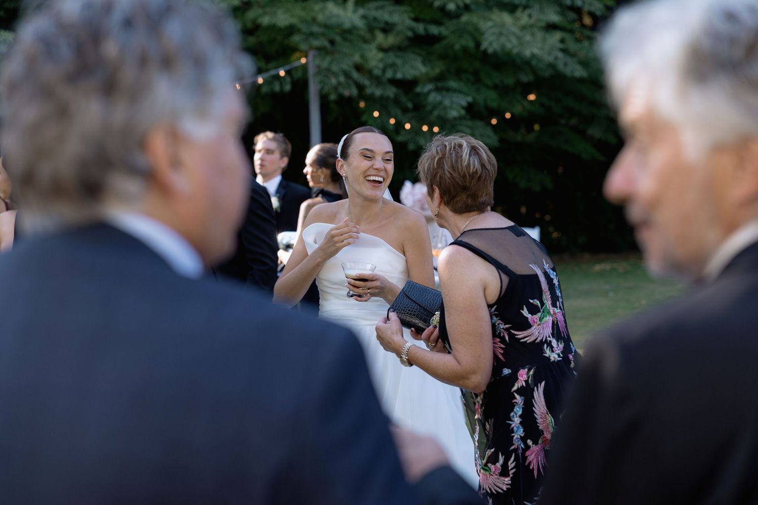 Wedding guests mingling and socializing during an outdoor reception.