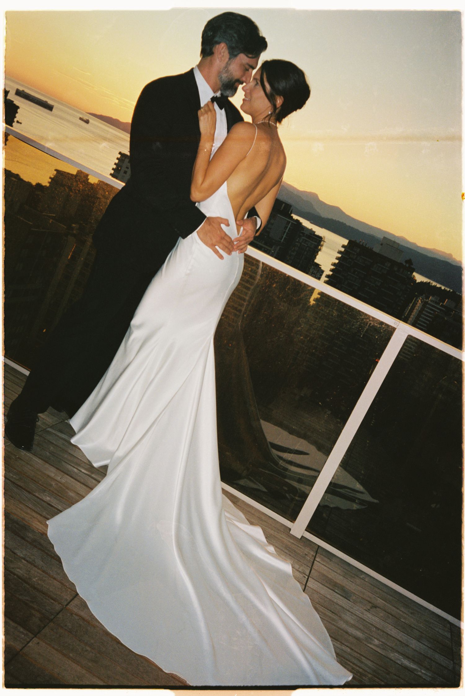 Sunset dance sequence on a wooden deck with warm golden lighting.