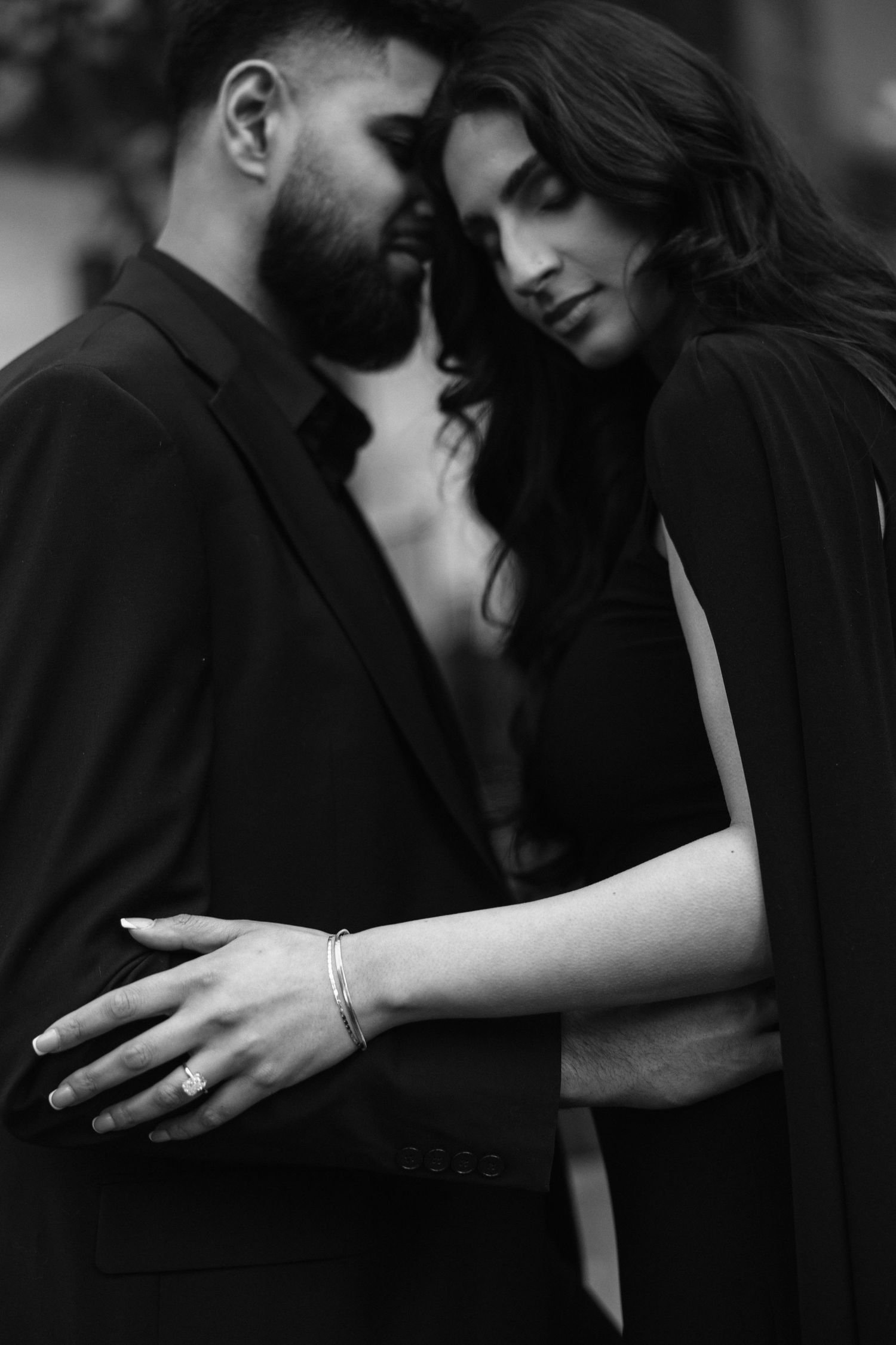 A series of black and white intimate romantic photos showing tender moments between a couple in close embrace.