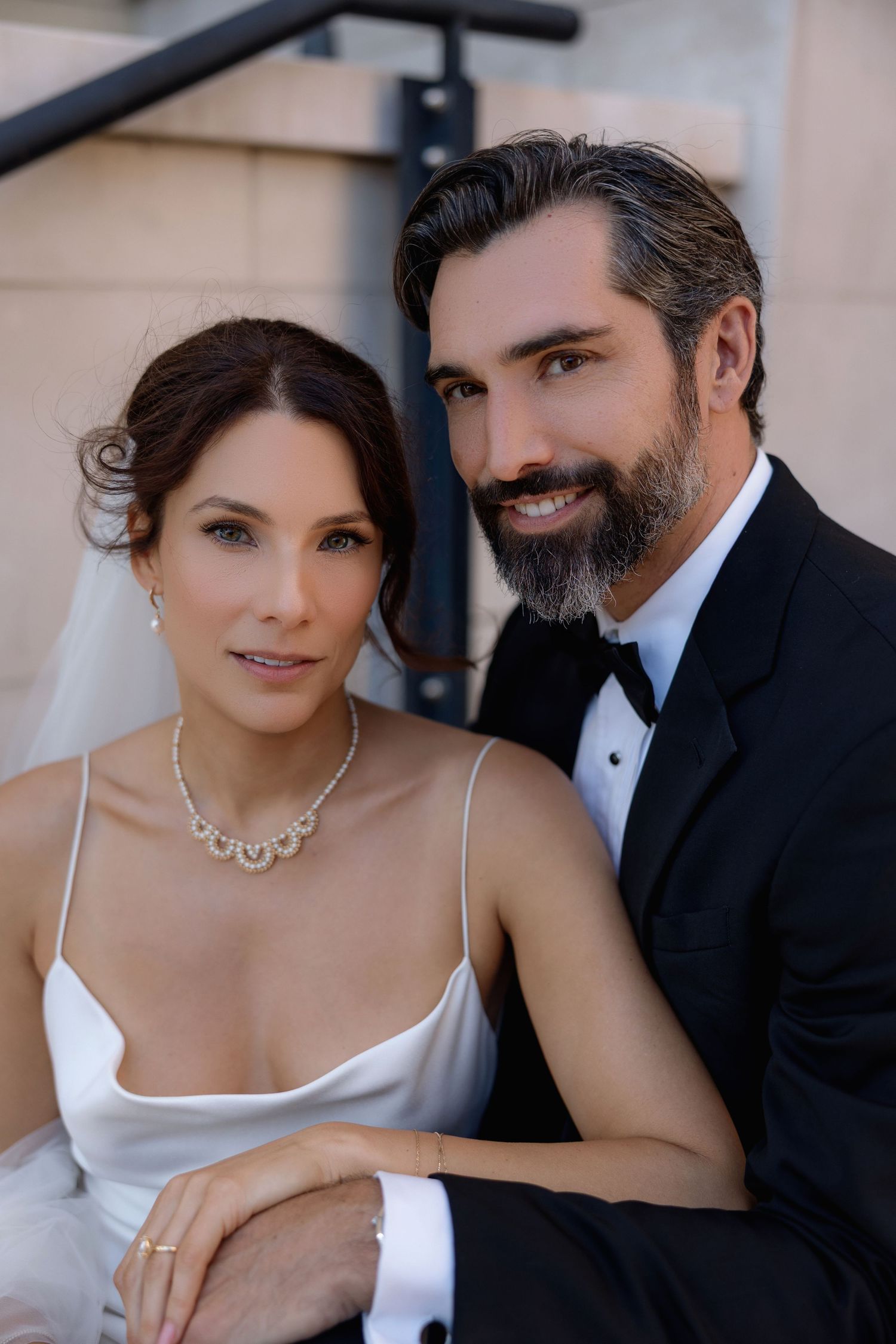 Romantic wedding portrait series showing tender moments between a couple in formal attire.