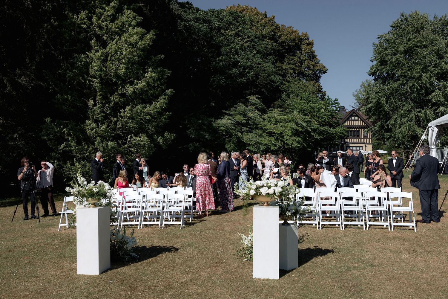 Wide shot of white chairs arranged in rows for an outdoor wedding ceremony at Hurt House in Burnaby