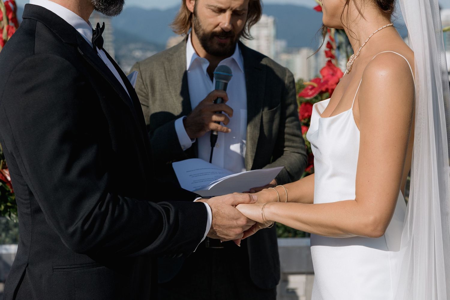 A series of wedding ceremony moments showing close-up shots of exchanging rings and holding hands at the altar.