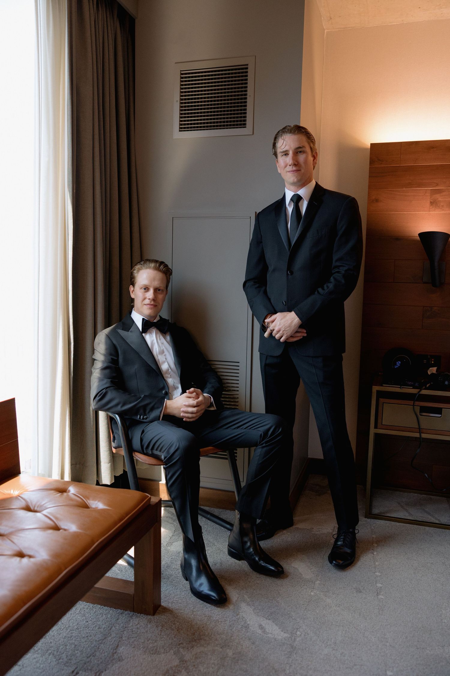 Formal portrait session with a groom in a modern hotel room with leather bench seating at Marriott Hotel in Vancouver