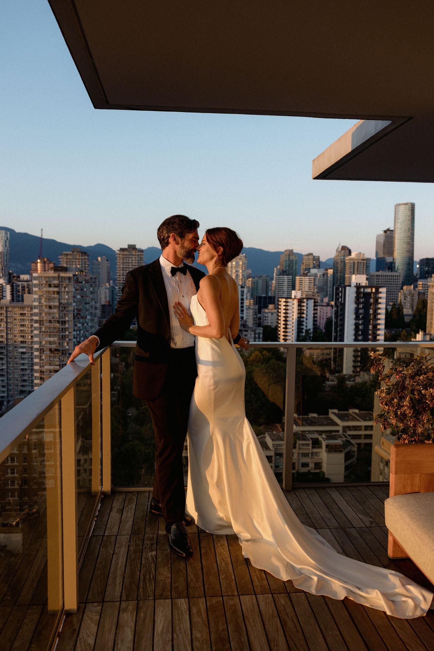 Romantic sunset moment on a rooftop balcony overlooking Vancouver's cityscape.